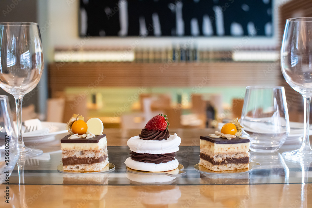 Selection of desserts, in a restaurant setting, with blurred background