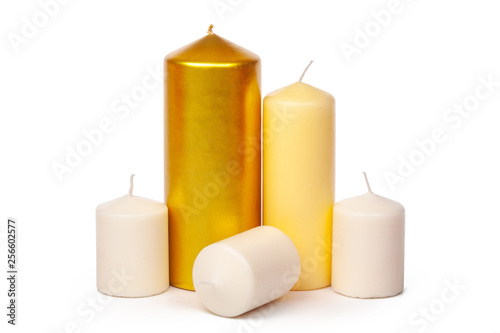 Golden and white colored candles isolated on white background