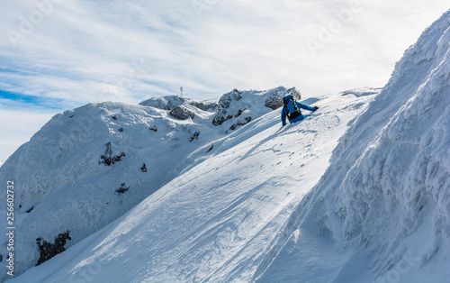 Snow on the waist. The tourist struggles to get out of the snow trap in the mountains.