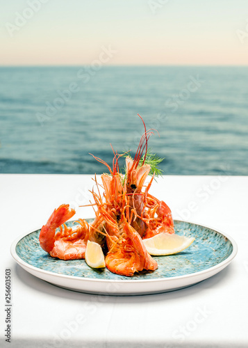 Shrimps on a plate against the background of the sea