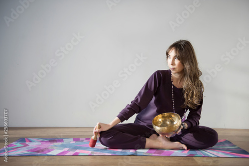 Young attractive woman practicing yoga. Girl is doing yoga. Stretching, working out, wearing sportswear. 