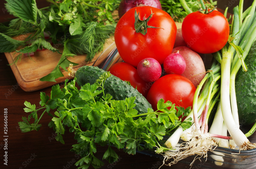 Appetizing vegetables and greens on the kitchen board