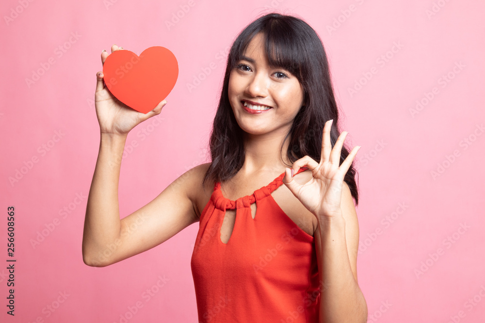 Asian woman show OK with red heart. Asian woman show OK with red heart.