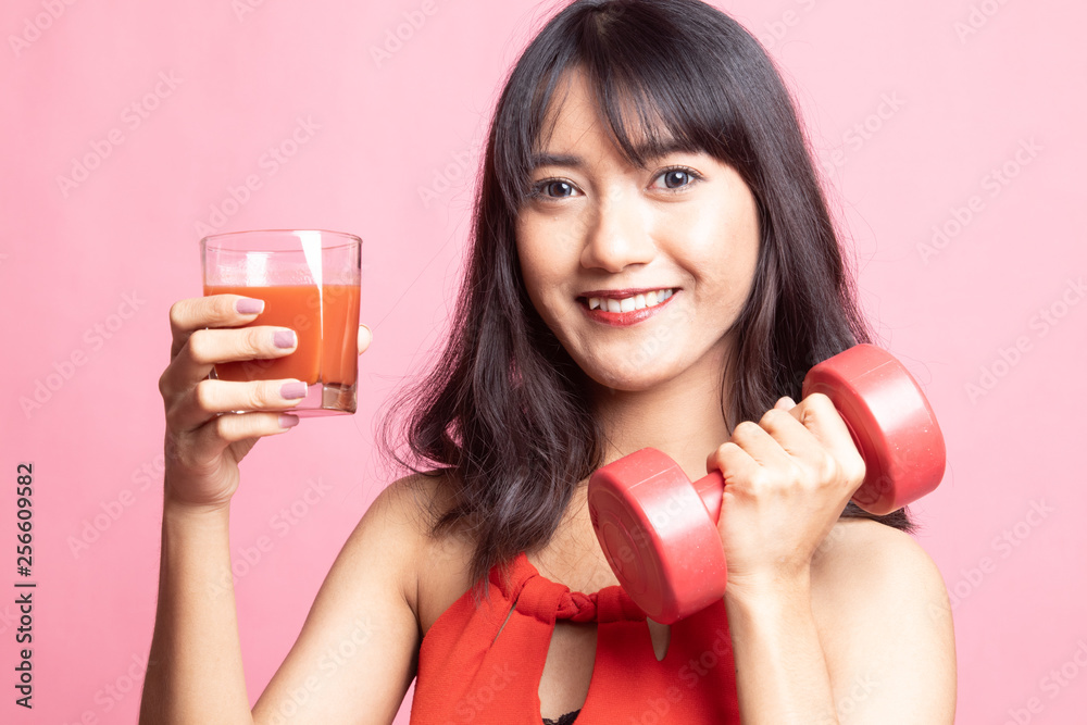 Healthy Asian woman with dumbbell and tomato juice. Healthy Asian woman with dumbbell and tomato juice.