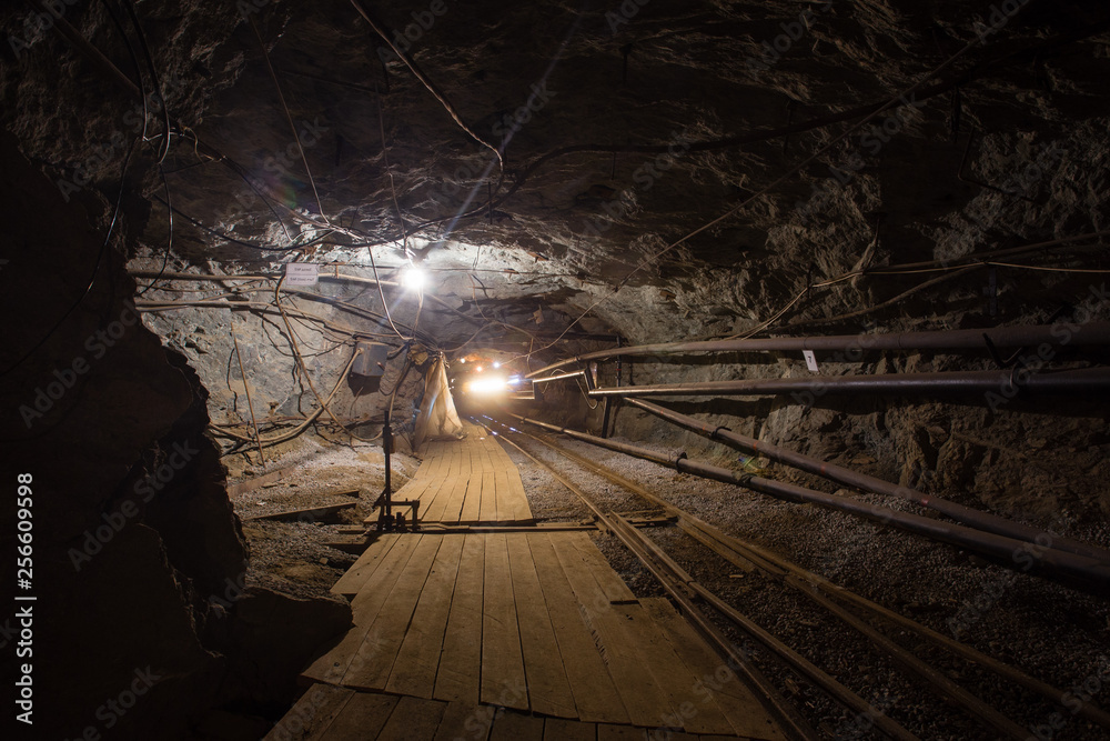 Naklejka premium Undeground gold mine tunnel drift with rails