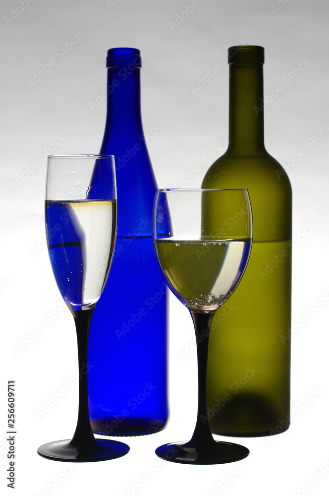 Wine in bottles and in glasses on a white background. Wine in bottles and in glasses on a white background.