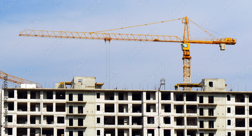 Crane near building. Construction site background.