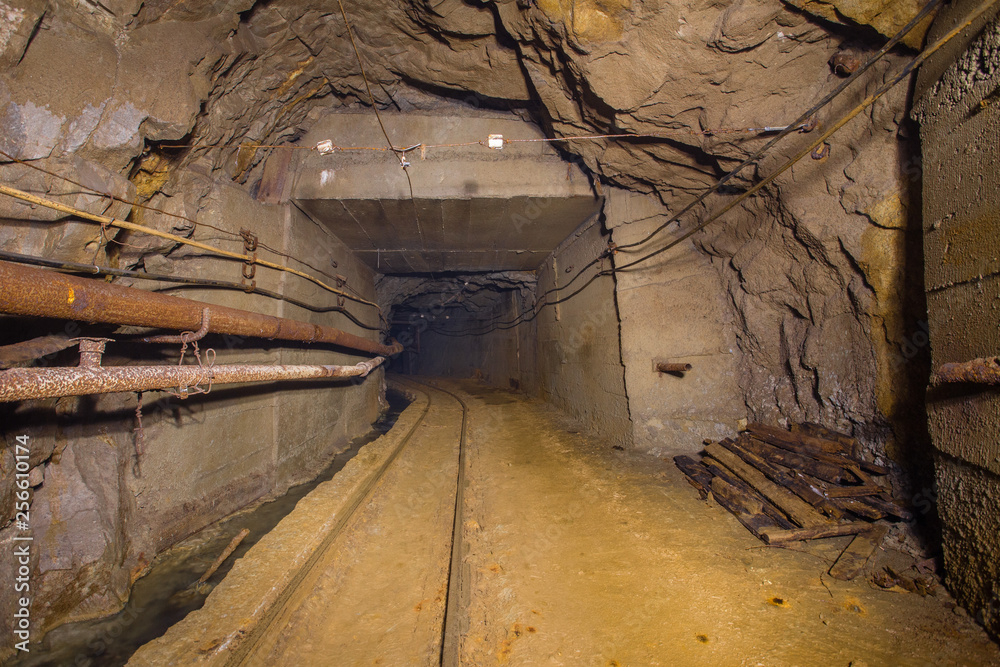 Underground gold mine tunnel drift with rails