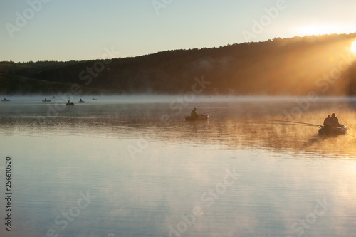 the lake with the fishermen of the sun's rays mist