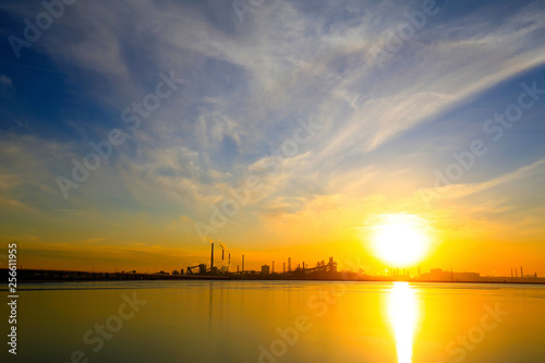 A silhouette of a chemical plant in the setting sun © hanmaomin