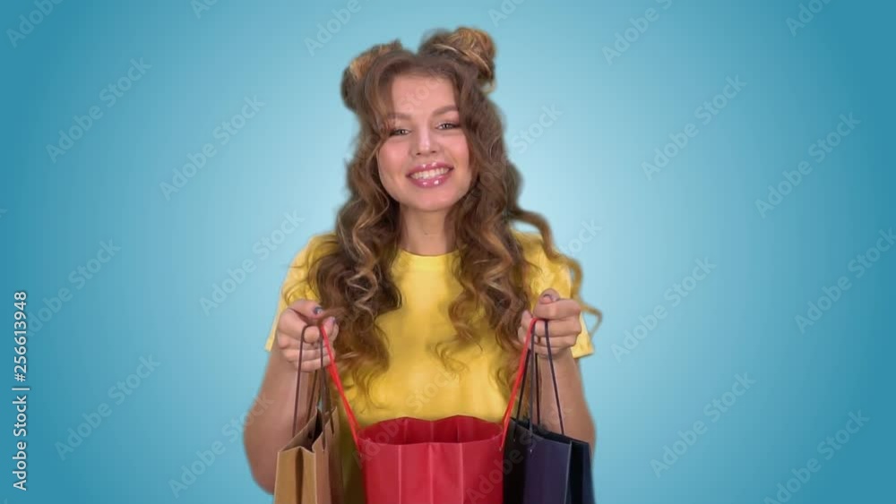 Attractive girl opens packages and enjoys shopping after shopping Attractive girl opens packages and enjoys shopping after shopping