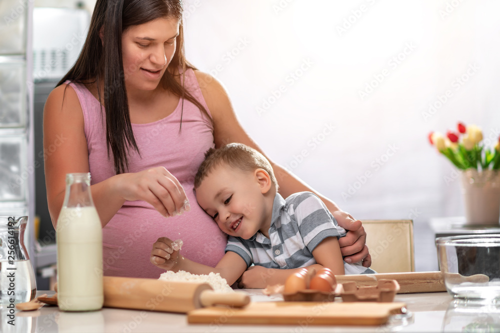 Mother and son kneading dough in the kitchen Mother and son kneading dough in the kitchen