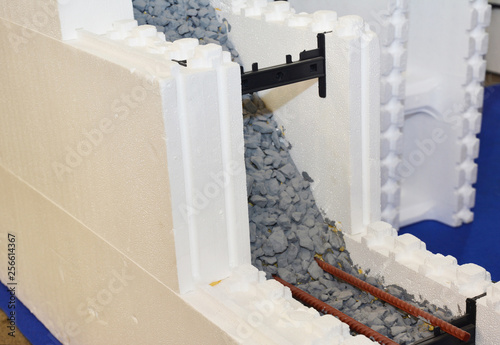 Insulating concrete forms ICF with reinforced concrete house walls. Insulating concrete forms ICF made of plastic foam that construction crews stack into the shape of the walls of a building.