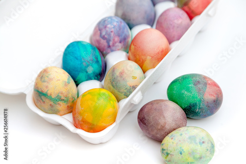 Group of Easter painted eggs in white container