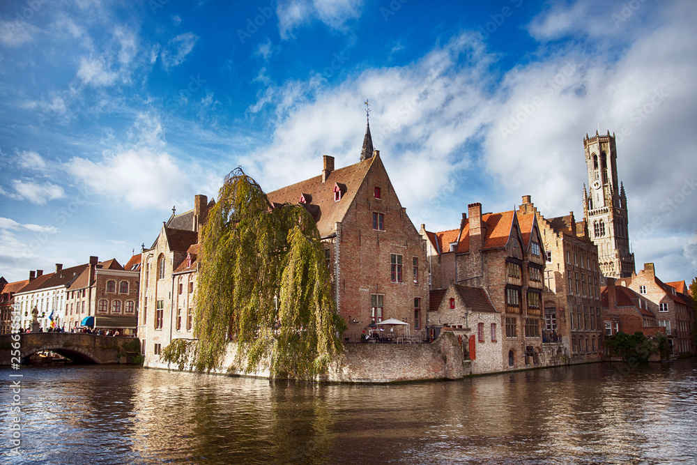 Ancient brick houses in Bruges Brugge , Belgium. Bruges is distinguished by its amazing canals that you can visit by boat, cobbled streets and medieval buildings. It's fascinating architecture has a
