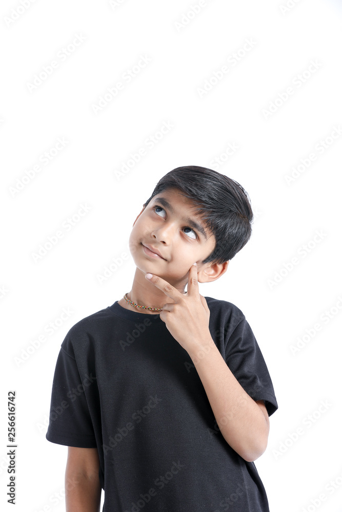Cute Indian boy thinking idea and looking at up, isolated on white background Cute Indian boy thinking idea and looking at up, isolated on white background