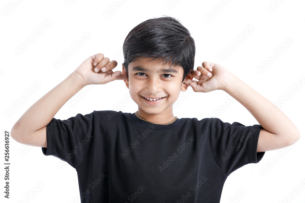 Indian little boy over isolated white background , covering ears with hands. Indian little boy over isolated white background , covering ears with hands.