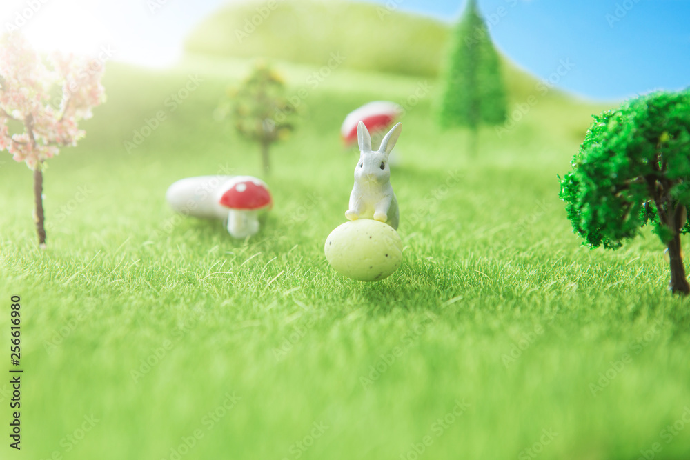 Naklejka premium Spring meadow with rabbit and easter egg. Fairy tale