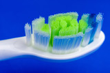 Detail of Electric toothbrush at blue background
