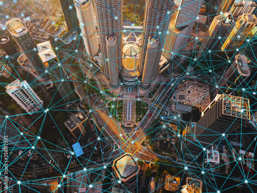 Digital network connection lines of Kuala Lumpur Downtown, Malaysia. Financial district and business centers in smart city in technology concept. Skyscraper and high-rise buildings at sunset photo