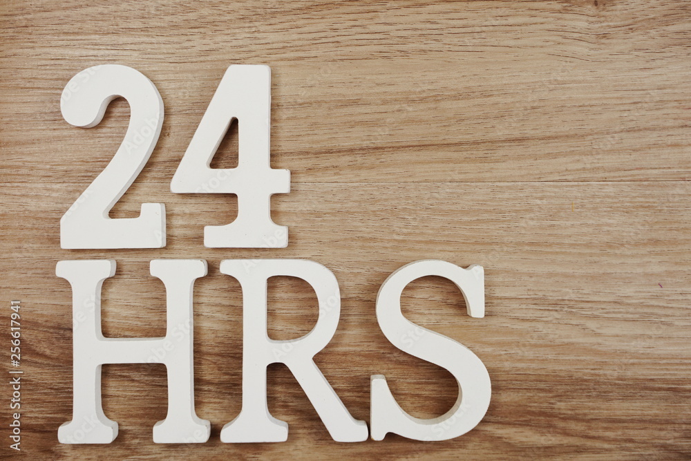 24 Hours alphabet letters Top view on Wooden background 24 Hours alphabet letters Top view on Wooden background