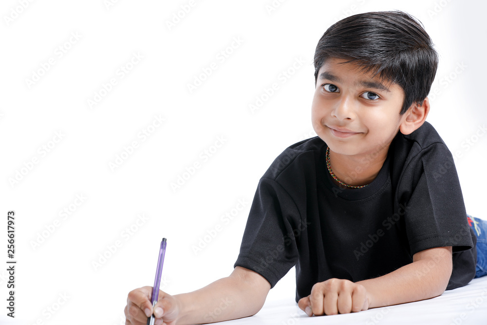 Indian child writing on note book Stock Photo | Adobe Stock