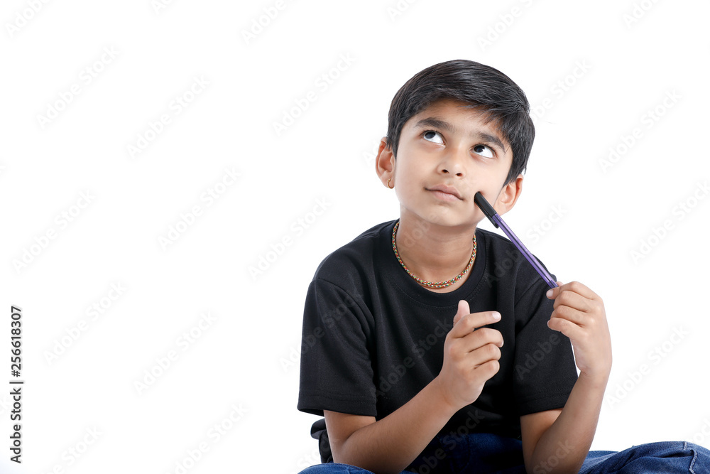 Cute Indian boy thinking idea and looking at up, isolated on white background Cute Indian boy thinking idea and looking at up, isolated on white background