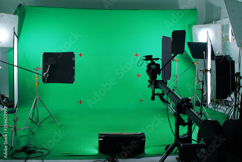 Green screen in studio with lighting equipments