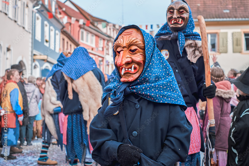Little witch in blue robe. Street Carnival in Southern Germany - Black Forest.