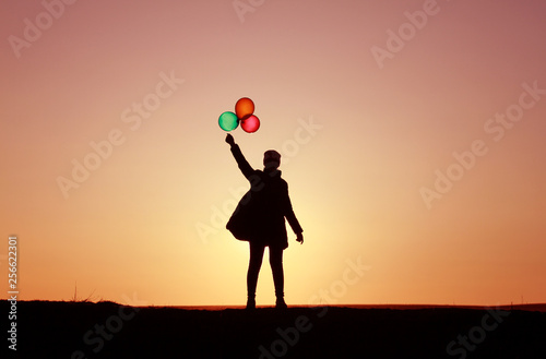 girl with balloons at sunset, colorful balloons, incredible sky sunset