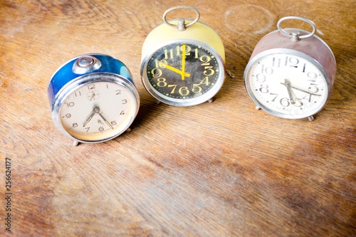 Group of old used alarm clocks red, blue- yellow. Obsolete technology but great design.
