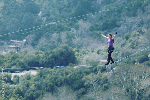 Womanbalancing on the rope concept of risk taking and challenge.