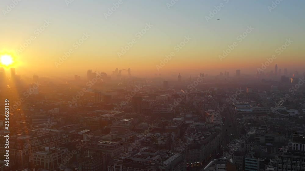 Video shows beautiful sunrise in London where the sun shines through the buildings and the city is in golden color Video shows beautiful sunrise in London where the sun shines through the buildings and the city is in golden color