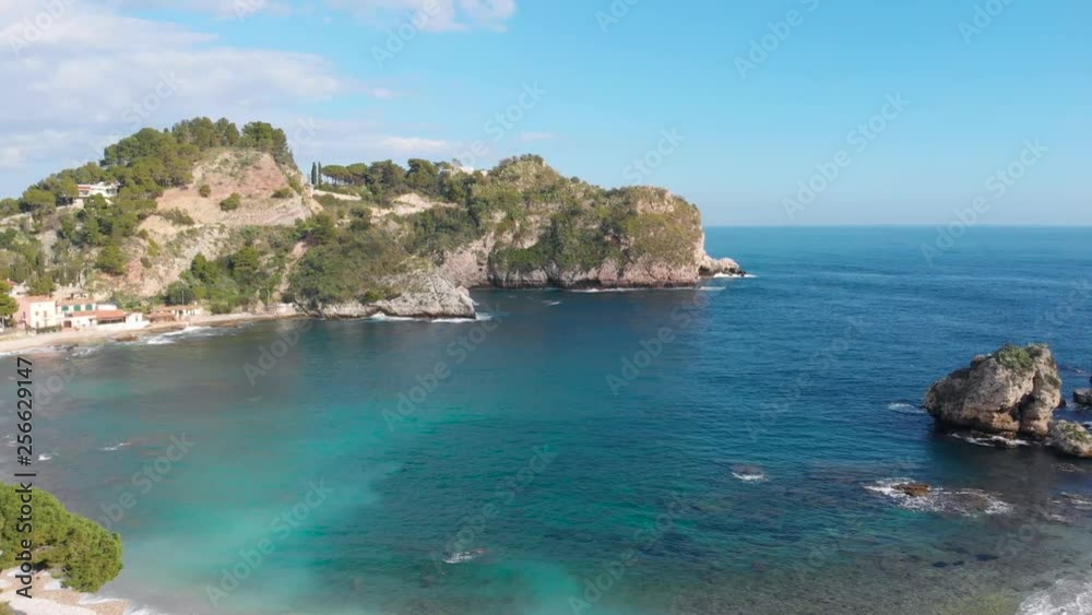 Aerial view of a calm bay and rocky land protecting the bay. Taormina, Sicily, Italy. Aerial view of a calm bay and rocky land protecting the bay. Taormina, Sicily, Italy.