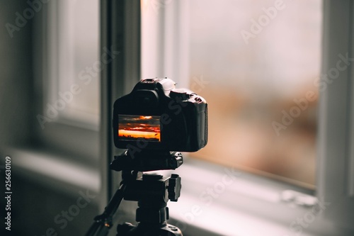 shooting a landscape with a camera on a tripod from the window of an apartment