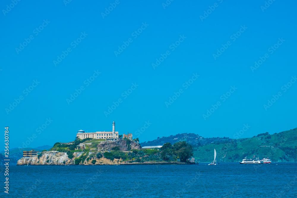 Alcatraz island view with boats for tourist, blue sky