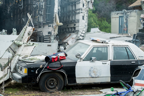 Accident scene the police car crashed with background of plane crash, catastrophe scene