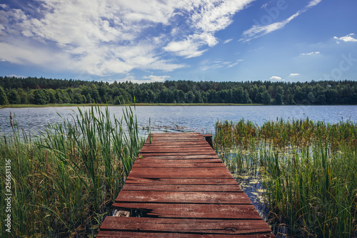 Small wooden pier on the shore of Lake Kramsko Duze in Wdzydze Landscape Park in Cassubia region, Poland