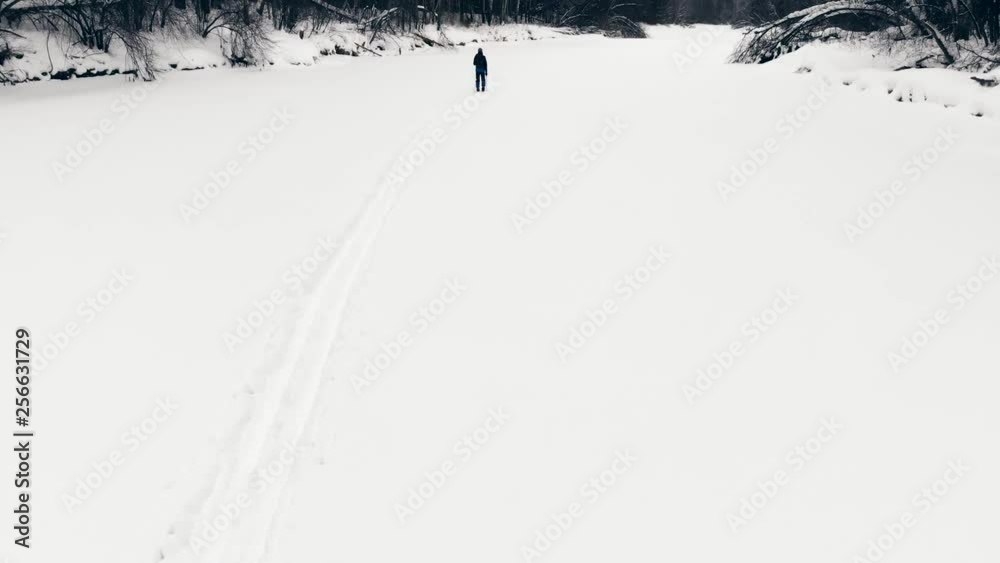 Dron flight above person cross country skiing. Winter Sports: A Skier Skiing Cross Country Trail. Winter Sports Active Lifestyle. Young Man Skier Skiing Countryside. Skiing Cross Country Winter Snow Dron flight above person cross country skiing. Winter Sports: A Skier Skiing Cross Country Trail. Winter Sports Active Lifestyle. Young Man Skier Skiing Countryside. Skiing Cross Country Winter Snow