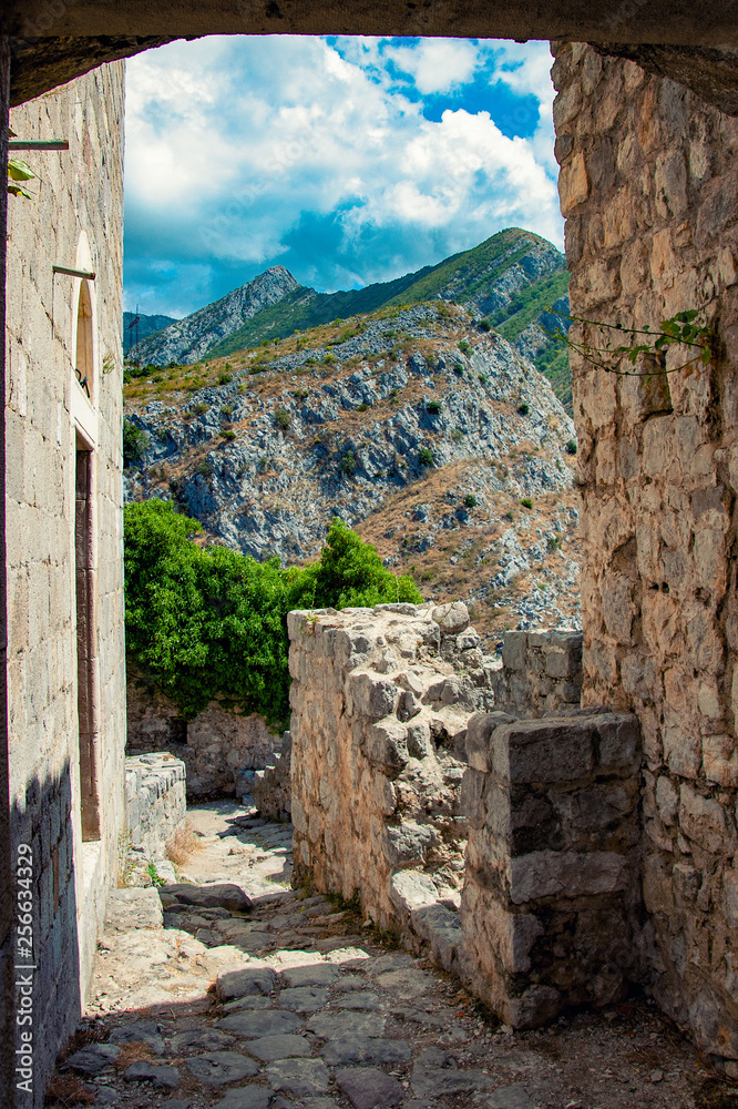 Ancient fortress in the city of Old Bar in Montenegro. Stone walls. View of the mountains and blue sky.
