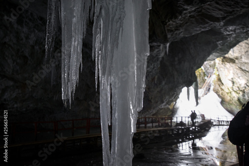 Underground glacier in Glaciers Cave in Apuseni mountains, Scarisoara, Romania. Big icicles holding on ceiling in the cave