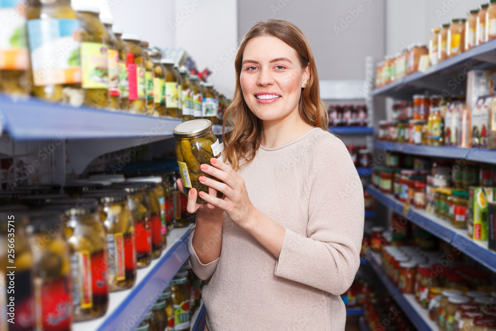 Female customer holding pickle goods in the food store
