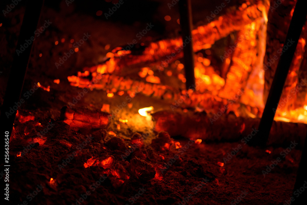 Ignite the fire. Warming up the cold winter nights. A macro shot of firewood, white dust and hot, glowing coal. Burning branches and wood. Flames in the fireplace, cozy home, warmth, love, romantic Ignite the fire. Warming up the cold winter nights. A macro shot of firewood, white dust and hot, glowing coal. Burning branches and wood. Flames in the fireplace, cozy home, warmth, love, romantic