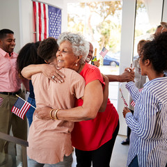 Senior black woman embracing her grandson at Independence Day family party,close up