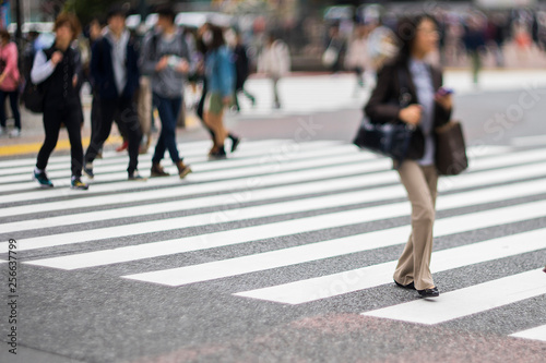 Blurry image of people crossing at crosswalk