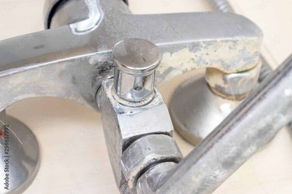 Detail of faucet with limescale or lime scale on it, dirty calcified and rusty shower mixer tap, close up Detail of faucet with limescale or lime scale on it, dirty calcified and rusty shower mixer tap, close up