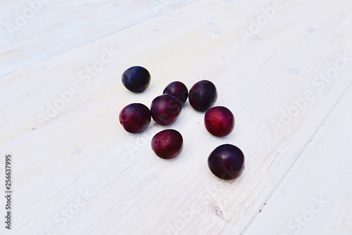 plums on wooden table