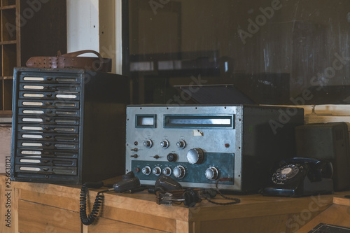 Vintage communication radio with old telephone in prison office