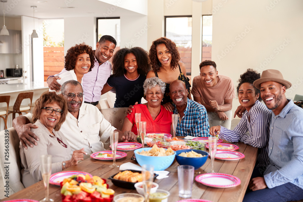 Senior black couples sitting at dinner table celebrating at home with family,selective focus