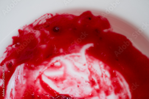 Stained with strawberry jam on white dish